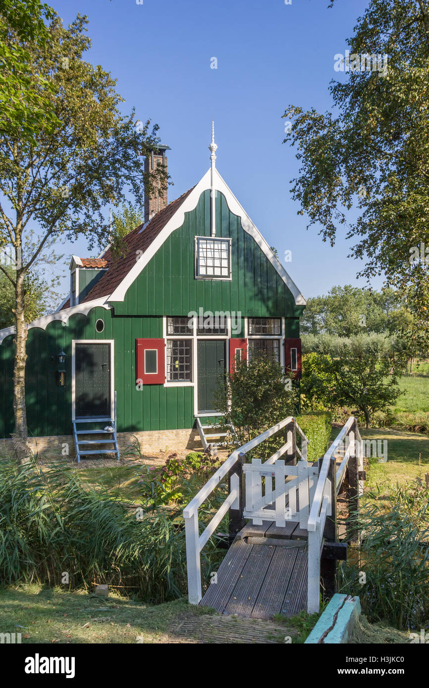 Little white bridge leading to a typical dutch wooden house in Zaanse Schans, The Netherlands Stock Photo
