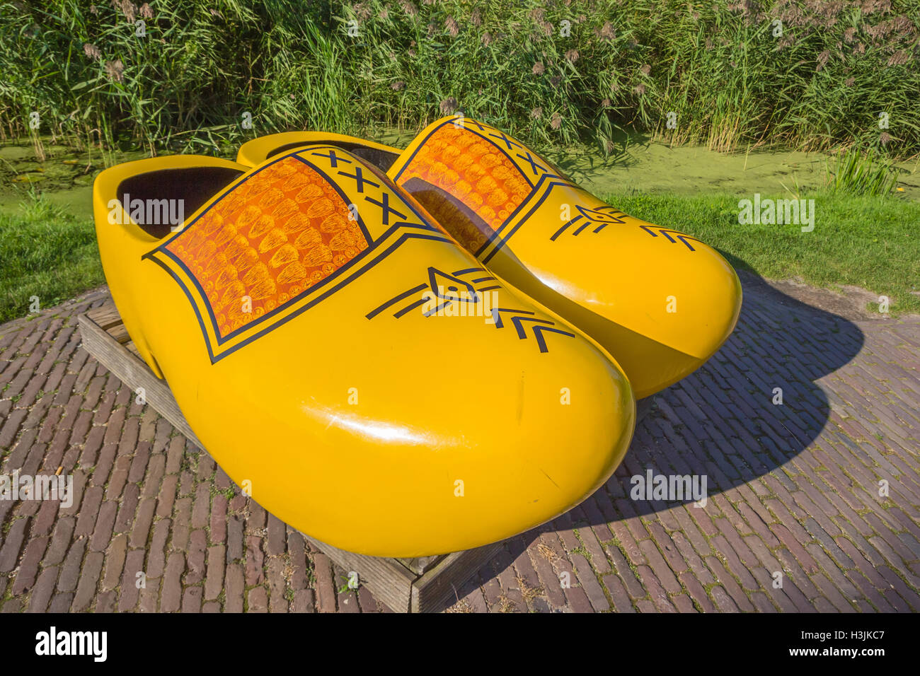 Pair of large yellow wooden shoes in Zaanse Schans, Holland Stock Photo