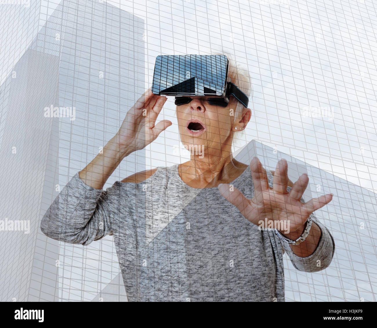 senior woman with VR virtual reality headset is stunned Stock Photo