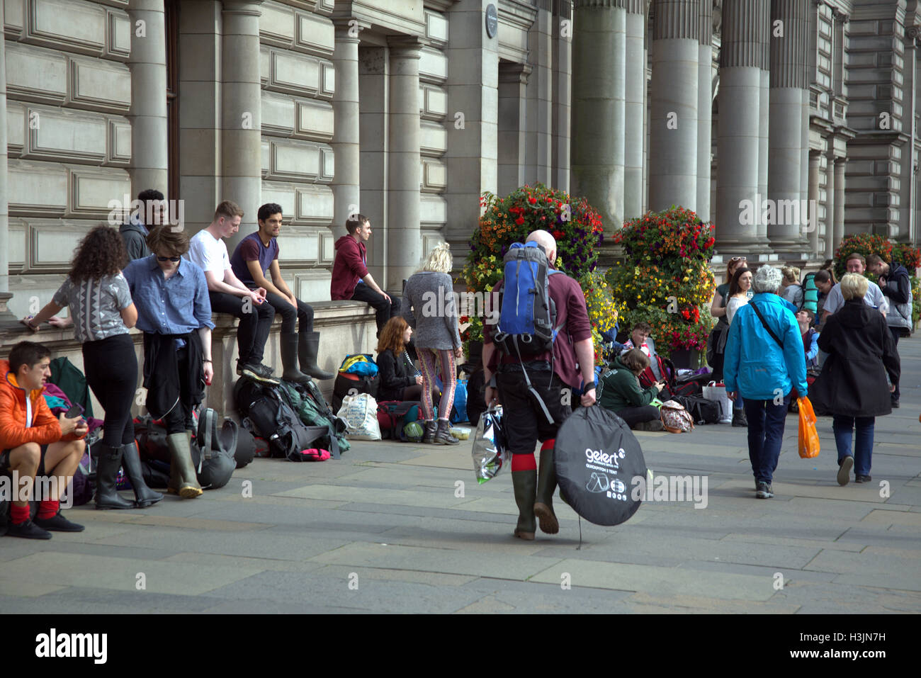 Festival goers in George Square Glasgow prepare to board buses to T in the park pop festival and carry all they need for the wee Stock Photo