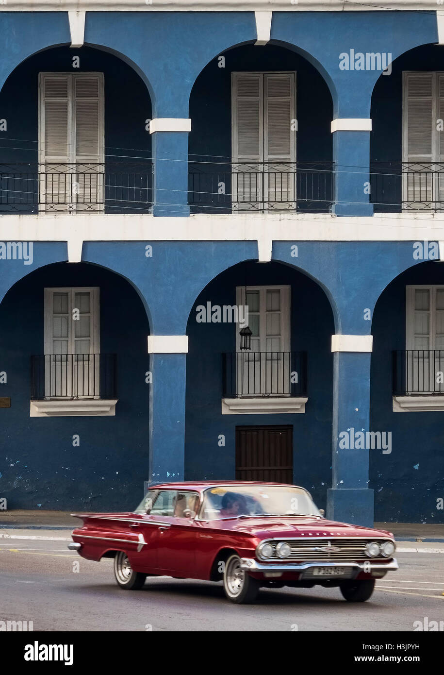 Red Cuban Car passing Museo Historico Provincial de Matanzas or Palacio de Junco, Plaza de La Viga, Matanzas, Cuba Stock Photo