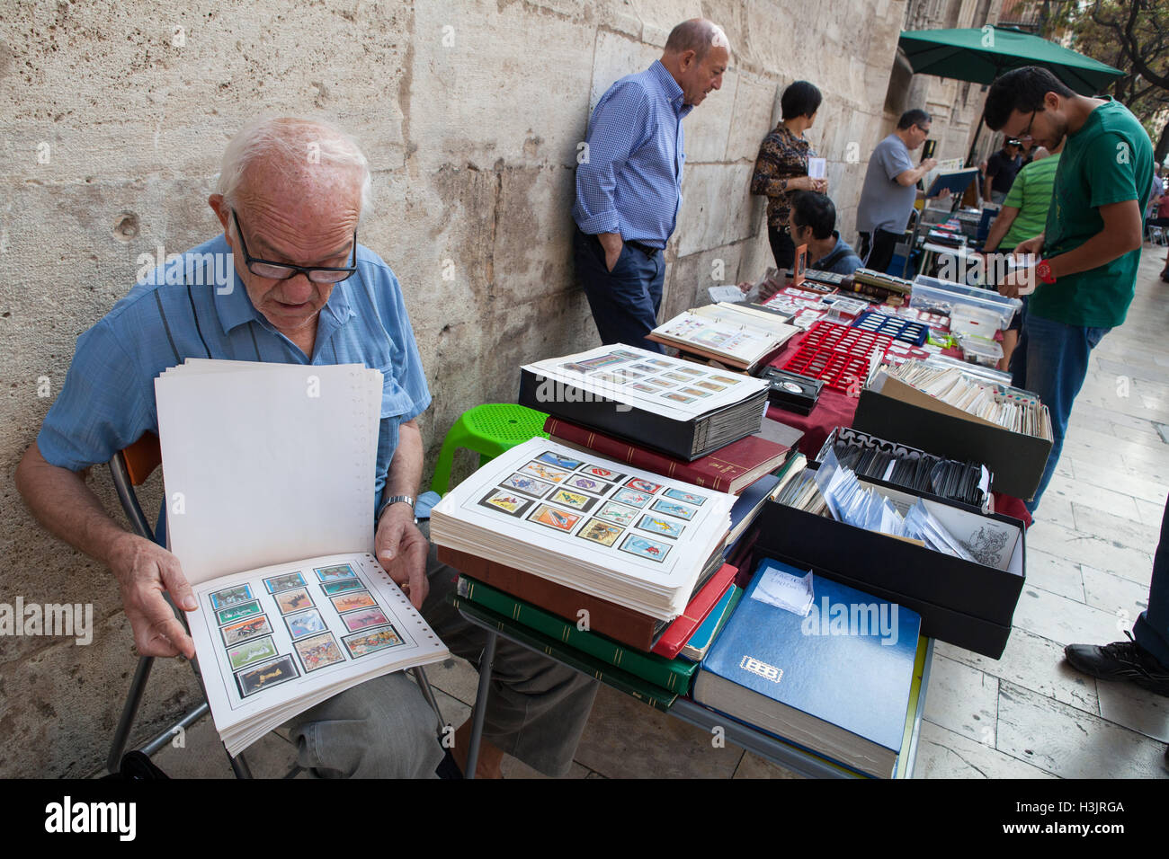 Stamp collectors at a flea market in the old quarter of Valencia Stock Photo
