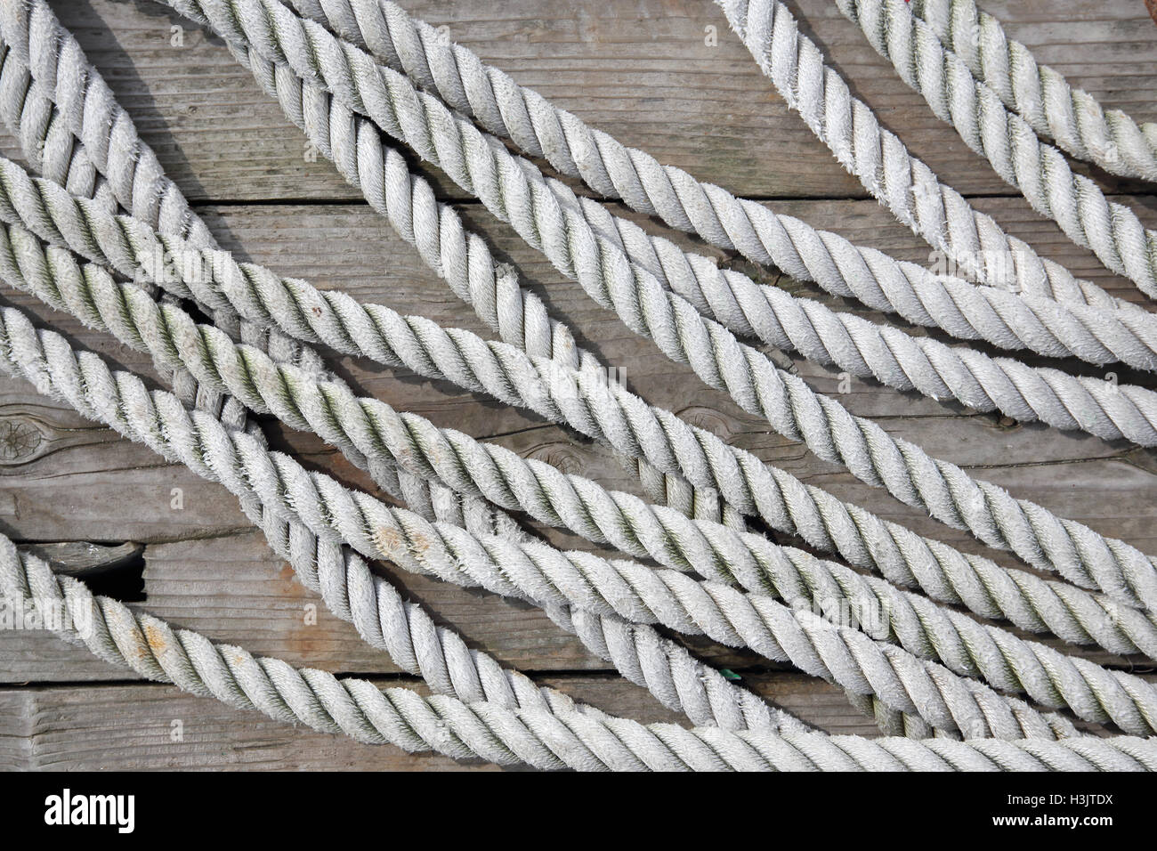 close up of old rope on wooden deck Stock Photo