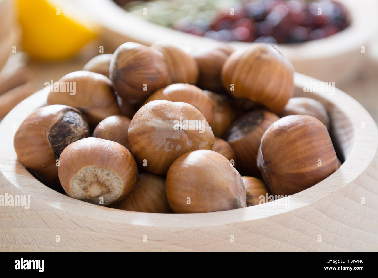 Hazelnuts in wooden bowl ready to be cracked and eaten Stock Photo Alamy