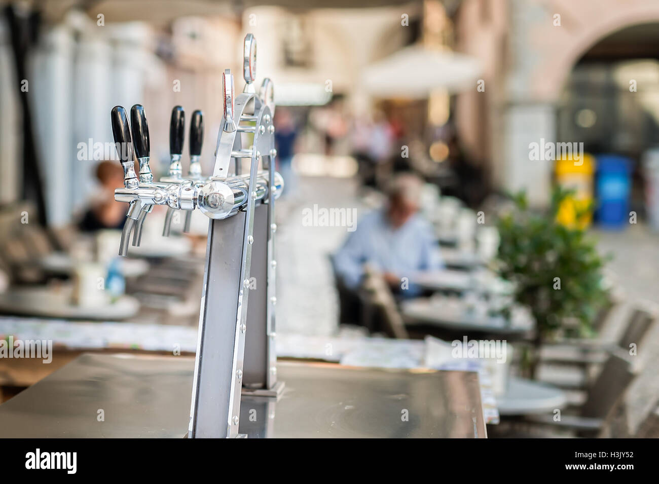 Draught beer taps and other beverages in a bar. Stock Photo