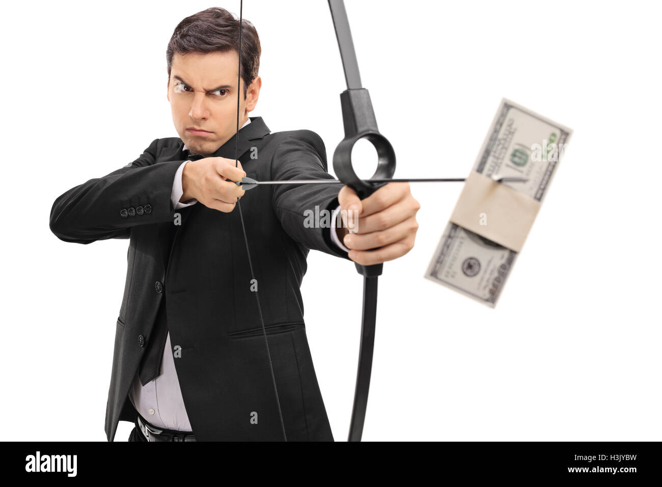 Young businessman aiming with a bow and arrow with a money bundle isolated on white background Stock Photo