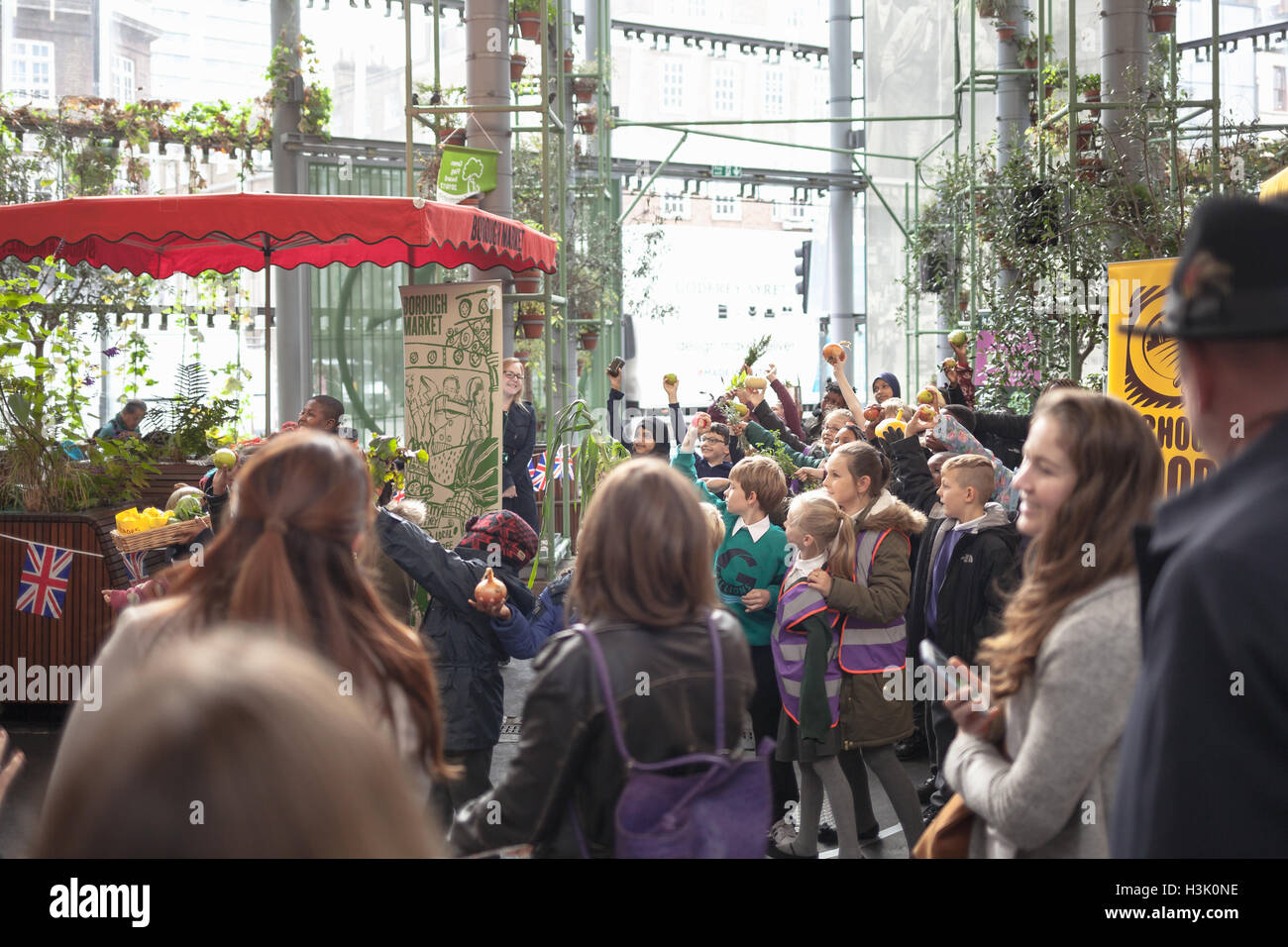 Borough Market, London UK, school kids playing with vegetables in the market on school food matter program Stock Photo