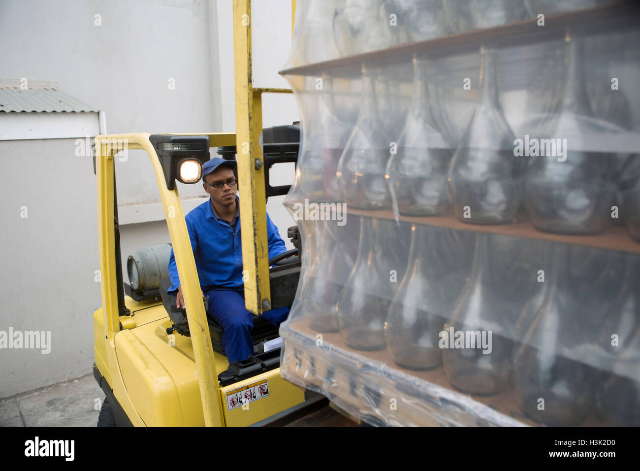 Forklift driver loading pallets at packaging factory Stock Photo Alamy