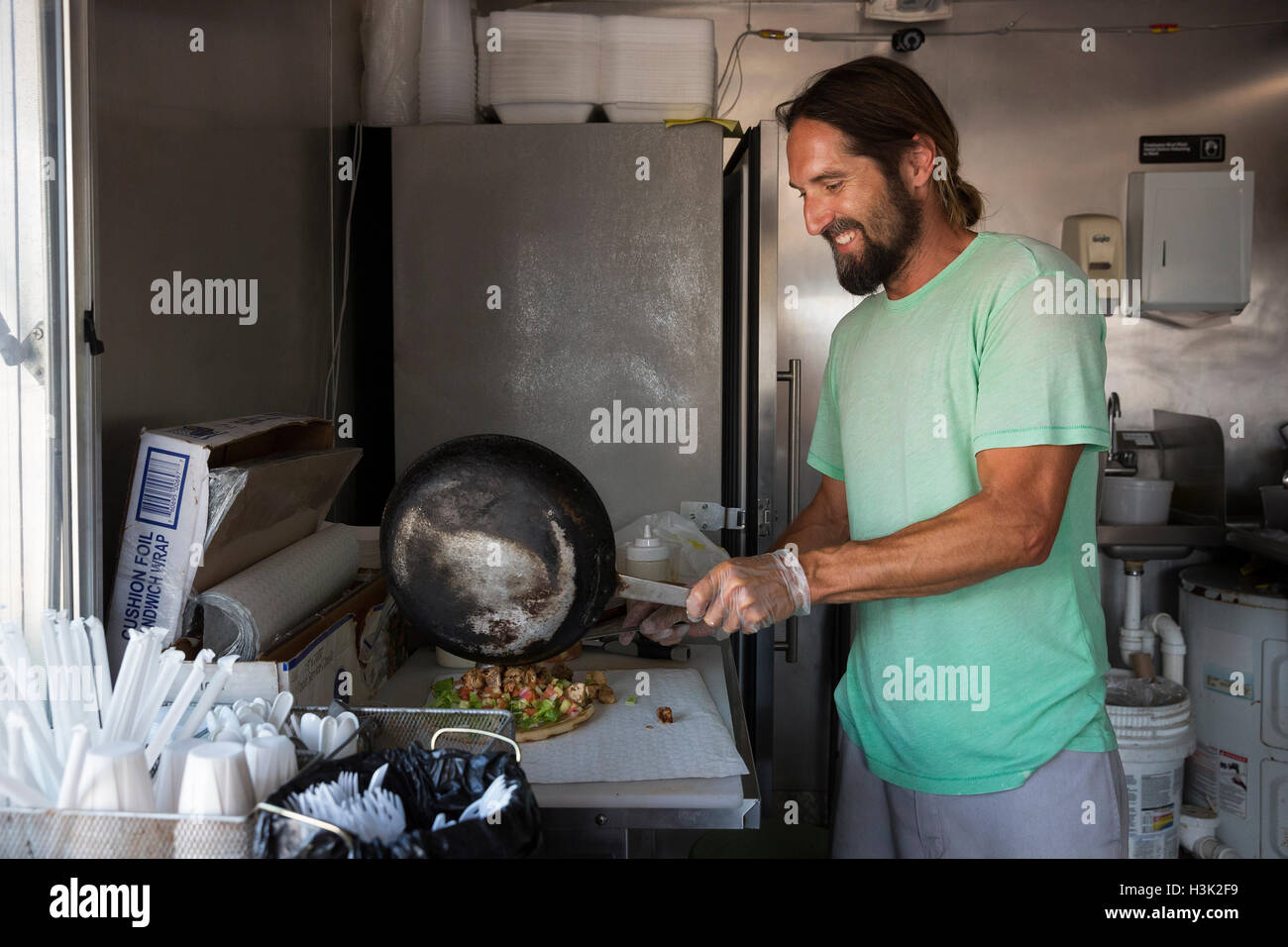 Man preparing order in fast food trailer Stock Photo Alamy