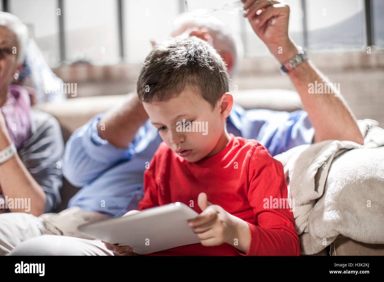 Boy using digital tablet at home Stock Photo - Alamy