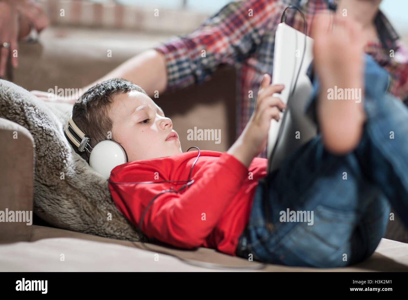 Boy using digital tablet at home Stock Photo - Alamy