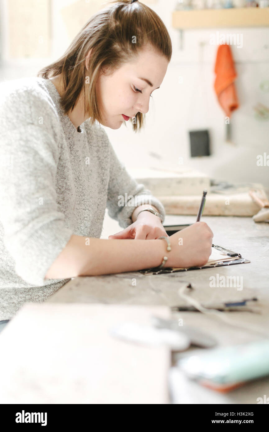 Artist working in pottery studio Stock Photo - Alamy