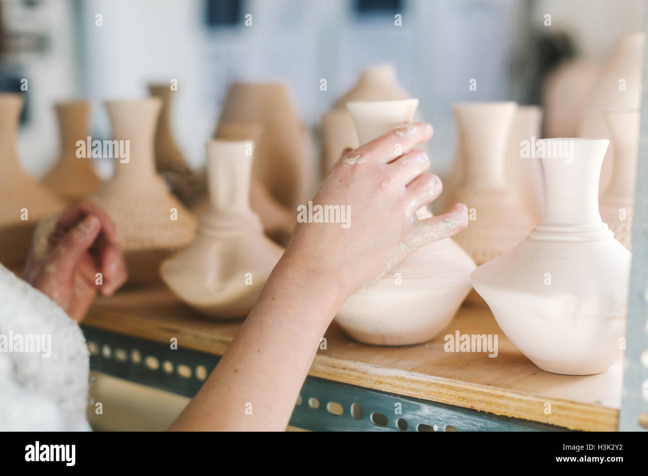 Artist working in pottery studio Stock Photo - Alamy