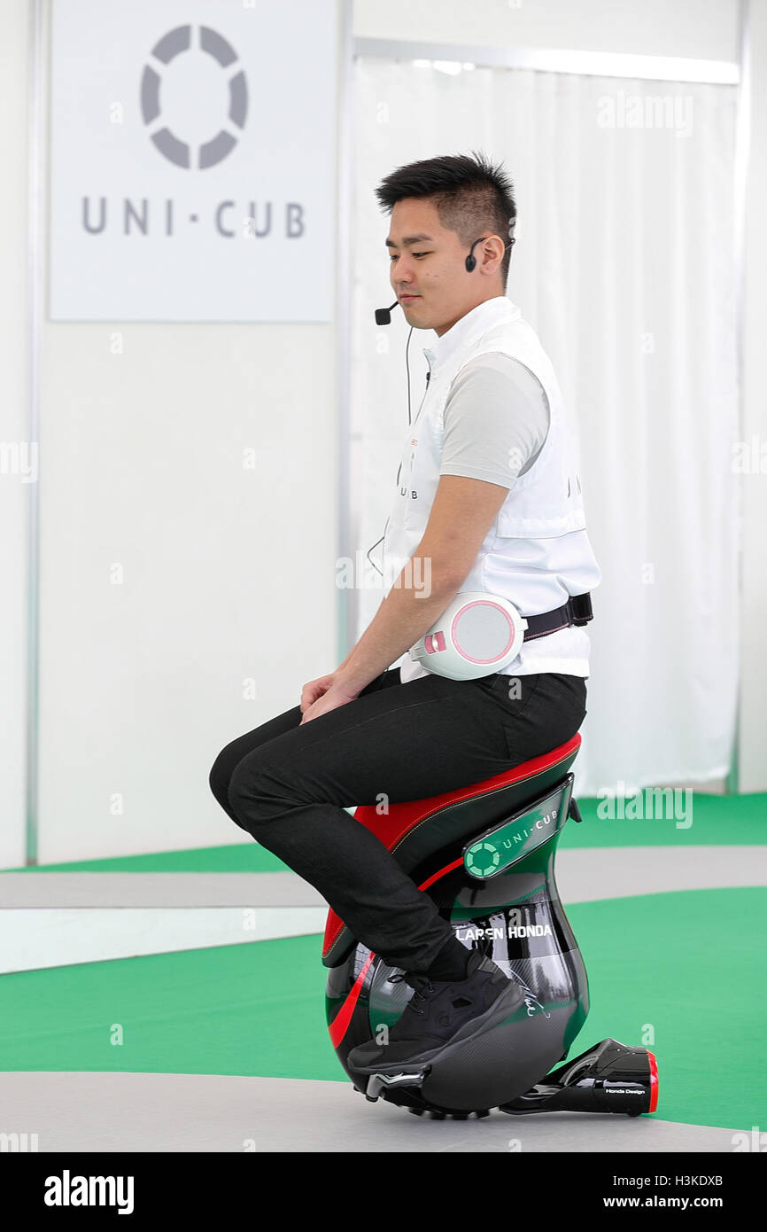 An exhibitor drives a personal device UNI-CUB during the Tokyo Motor Fes 2016 at Odaiba on October 10, 2016, Tokyo, Japan. The annual festival provides an opportunity for visitors of all ages to interact with motor vehicles from Japanese and overseas auto manufacturers. This year organizers set up a 360 degrees VR (Virtual Reality) Dome where visitors can experience the thrills of riding through virtual reality. The exhibition runs from October 8 to 10. Credit:  Rodrigo Reyes Marin/AFLO/Alamy Live News Stock Photo