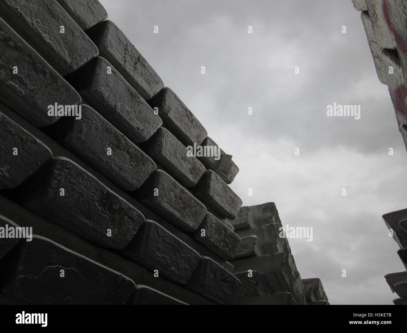 Puerto Ordaz, Venezuela, 10 October 2016.  Weather in Venezuela. Fully it dawned cloudy day in the city this South American country. This image shows a stack of several aluminum ingots produced in an aluminum reduction plant, these companies are mostly in this area of the country, on the photo completely gray sky in the background can be seen. Jorgeprz / Alamy Live News. Stock Photo