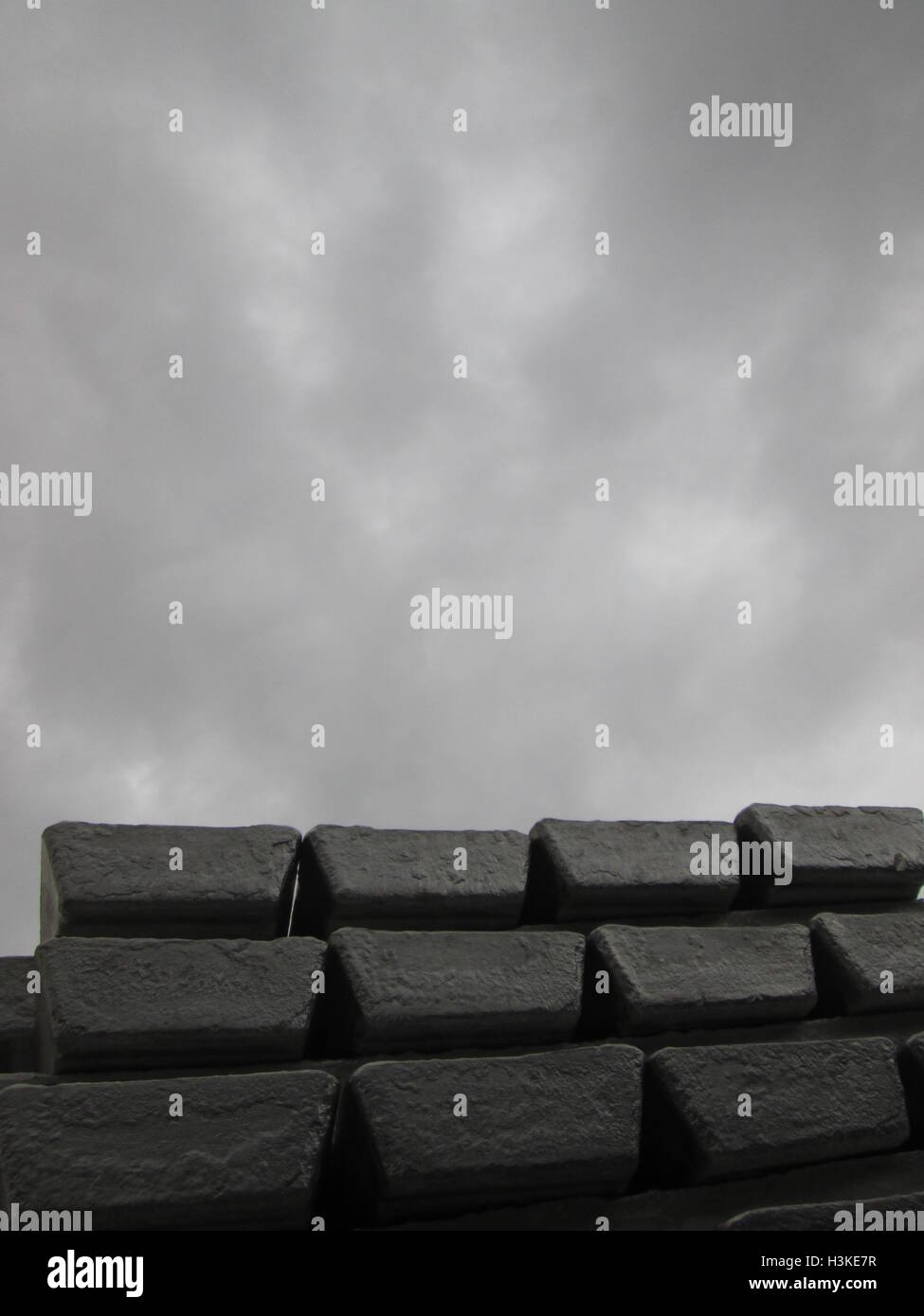 Puerto Ordaz, Venezuela, 10 October 2016.  Weather in Venezuela. Fully it dawned cloudy day in the city this South American country. This image shows a stack of several aluminum ingots produced in an aluminum reduction plant, these companies are mostly in this area of the country, on the photo completely gray sky in the background can be seen. Jorgeprz / Alamy Live News. Stock Photo