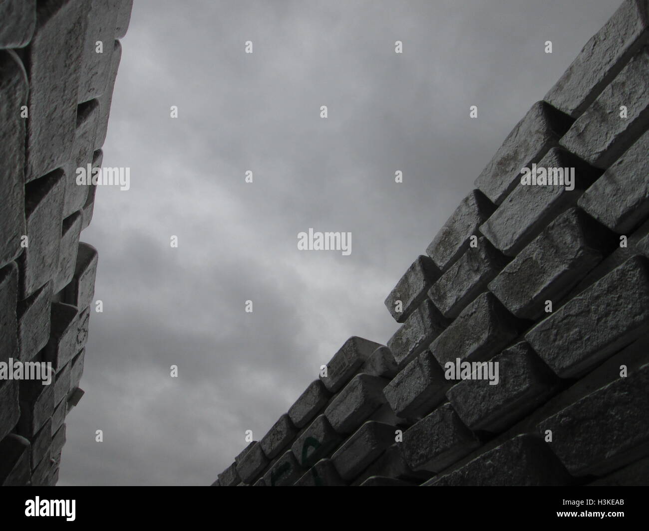 Puerto Ordaz, Venezuela, 10 October 2016.  Weather in Venezuela. Fully it dawned cloudy day in the city this South American country. This image shows a stack of several aluminum ingots produced in an aluminum reduction plant, these companies are mostly in this area of the country, on the photo completely gray sky in the background can be seen. Jorgeprz / Alamy Live News. Stock Photo