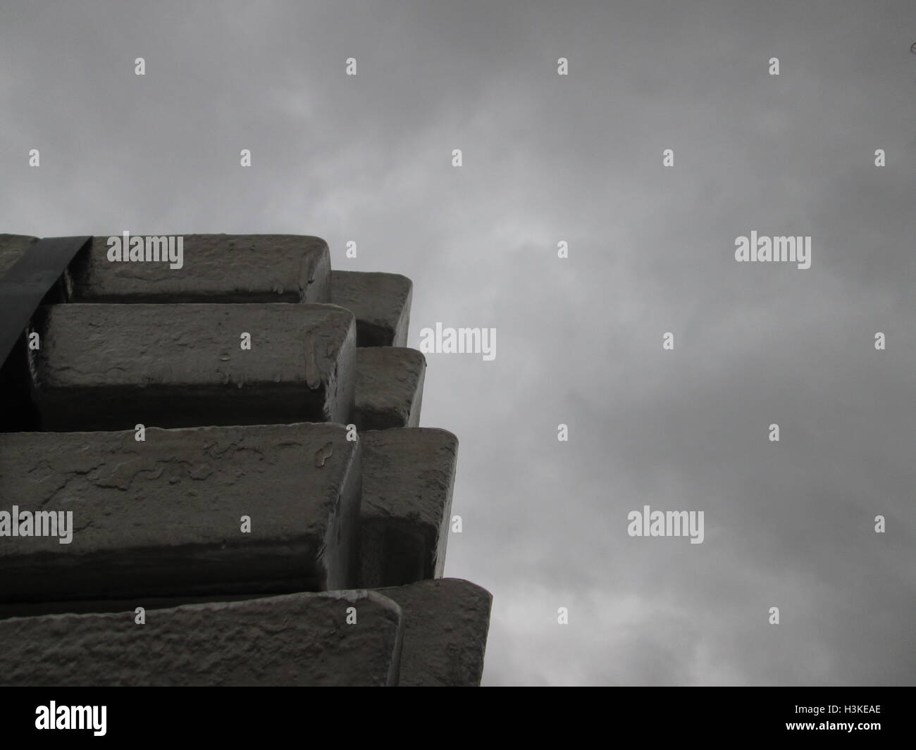 Puerto Ordaz, Venezuela, 10 October 2016.  Weather in Venezuela. Fully it dawned cloudy day in the city this South American country. This image shows a stack of several aluminum ingots produced in an aluminum reduction plant, these companies are mostly in this area of the country, on the photo completely gray sky in the background can be seen. Jorgeprz / Alamy Live News. Stock Photo