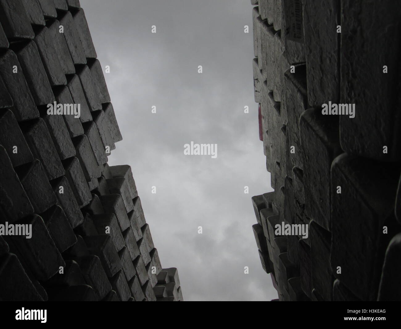 Puerto Ordaz, Venezuela, 10 October 2016.  Weather in Venezuela. Fully it dawned cloudy day in the city this South American country. This image shows a stack of several aluminum ingots produced in an aluminum reduction plant, these companies are mostly in this area of the country, on the photo completely gray sky in the background can be seen. Jorgeprz / Alamy Live News. Stock Photo