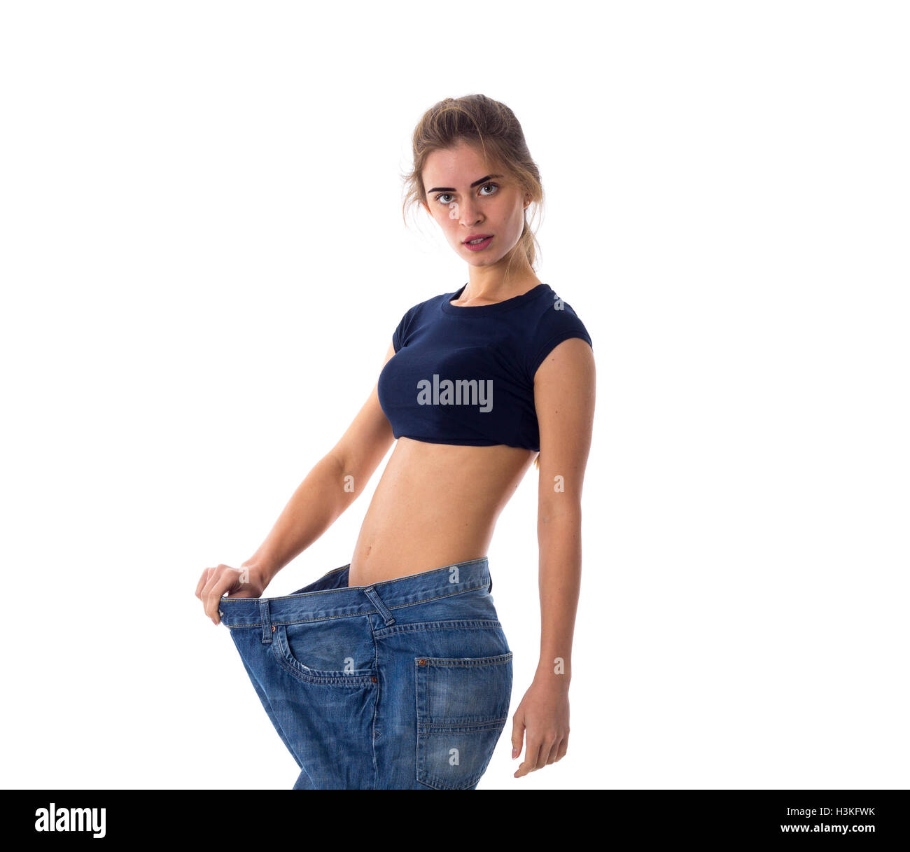 Woman wearing jeans of much bigger size Stock Photo Alamy