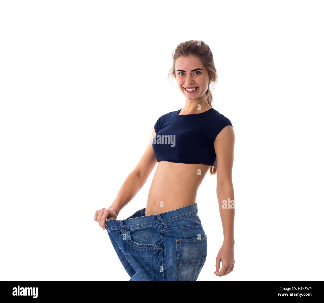 Woman wearing jeans of much bigger size Stock Photo Alamy