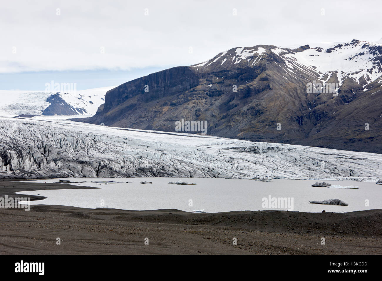 ash covered Skaftafell glacier and melt water glacial lagoon Vatnajokull national park in Iceland Stock Photo