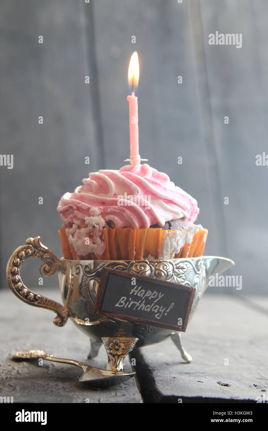 Cupcake and birthday candle Stock Photo