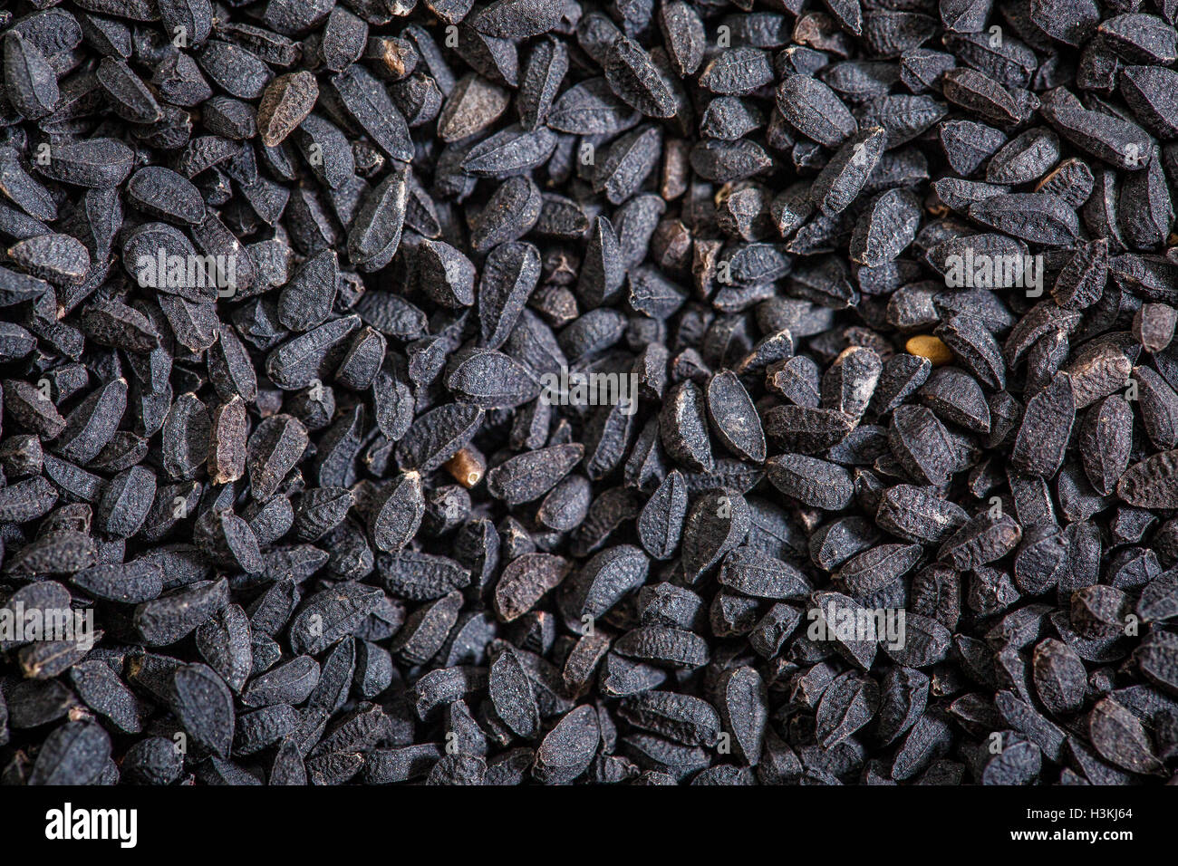 black cumin seeds (Nigella sativa) - closeup background Stock Photo