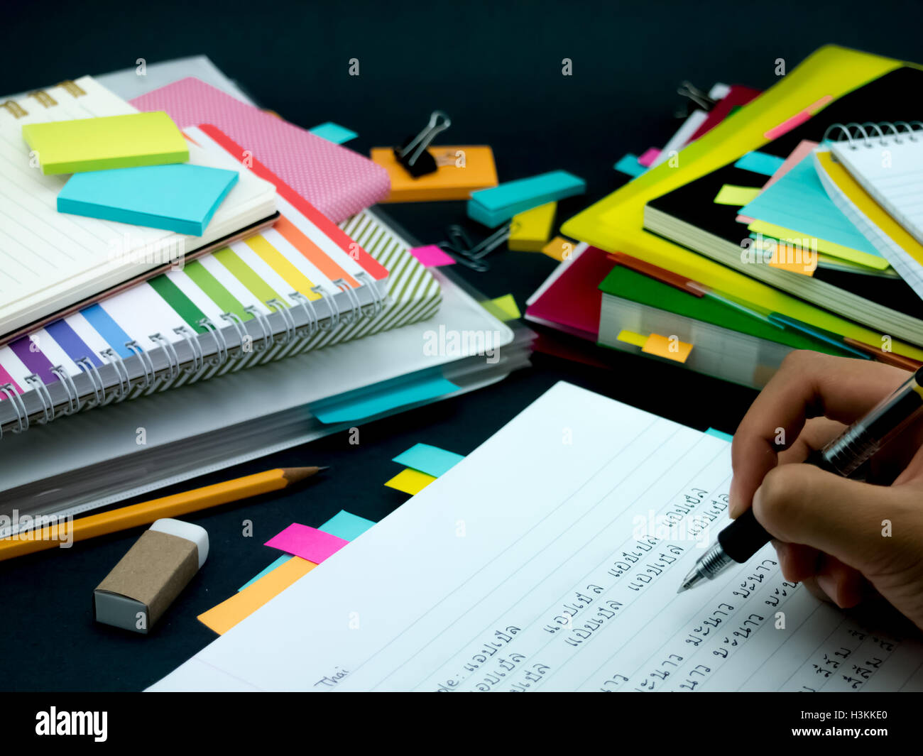 Learning New Language Writing Words Many Times on the Notebook; Thai (Translation; Apple) Stock Photo