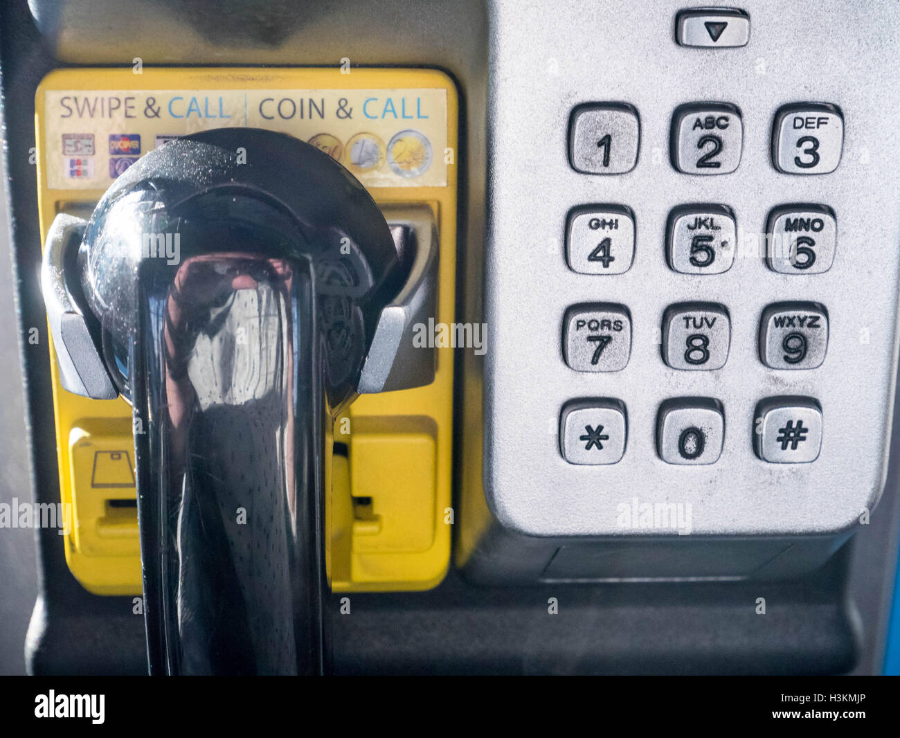 Coin or credit card telephone in airport in Germany airport with tactile numeric keys and black headset Stock Photo
