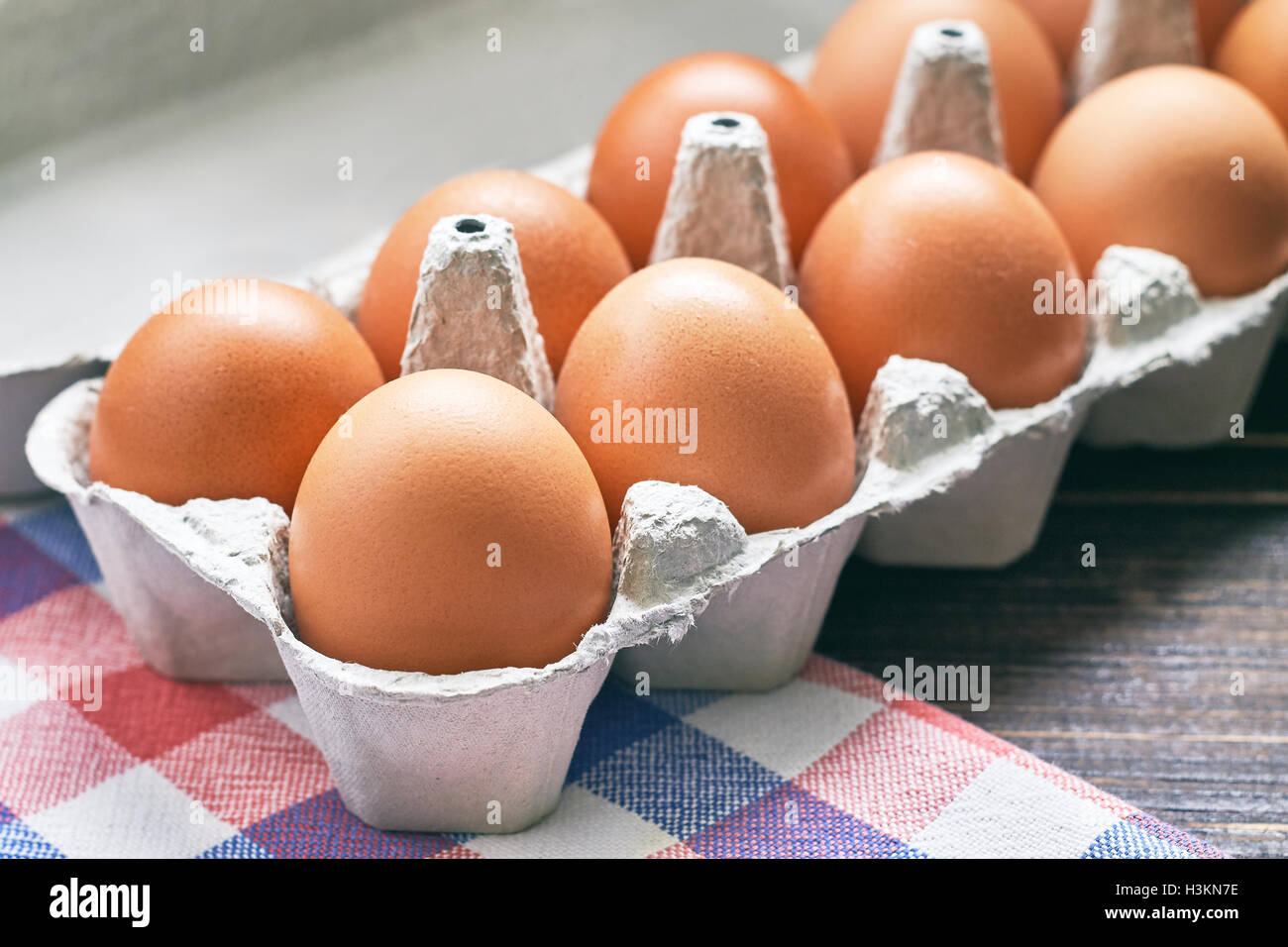 Chicken eggs in pulp egg carton on table Stock Photo