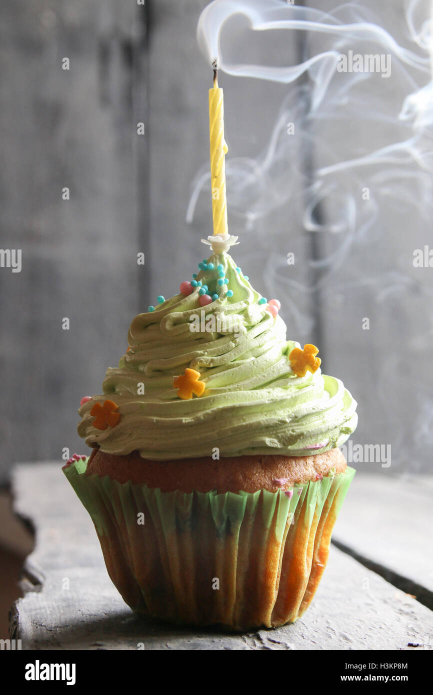 delicious Birthday cake with one candle, floating smoke Stock Photo Alamy