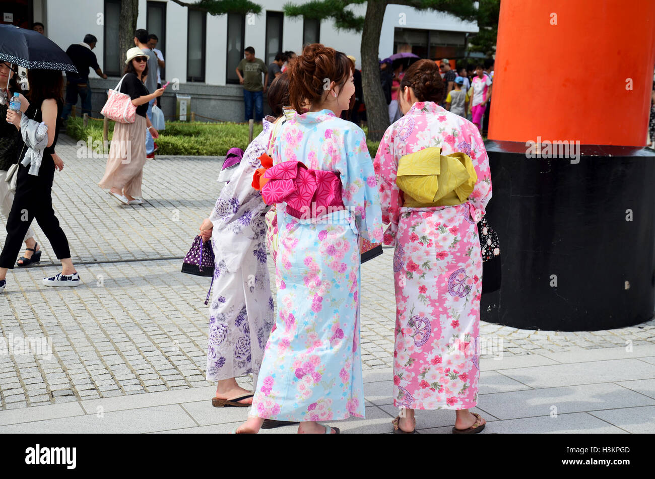 Japanese women wear traditional Japanese clothing (Kimono and Yukatas) and  travelers peopke walking to inside at Fushimi Inari S Stock Photo - Alamy
