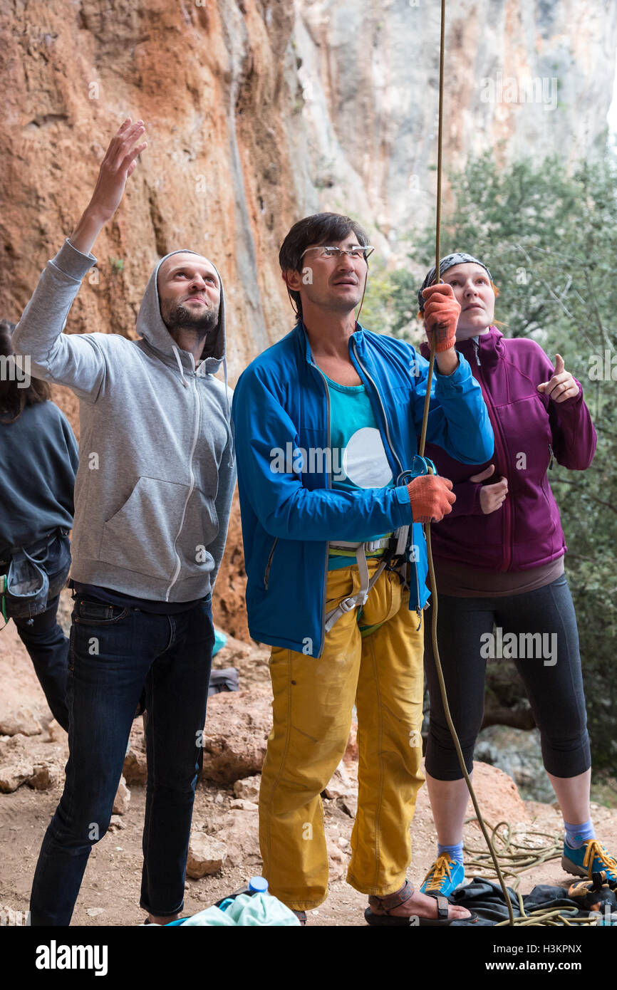 Group of Climbers belays Leader with Mature Coach in the middle Stock Photo