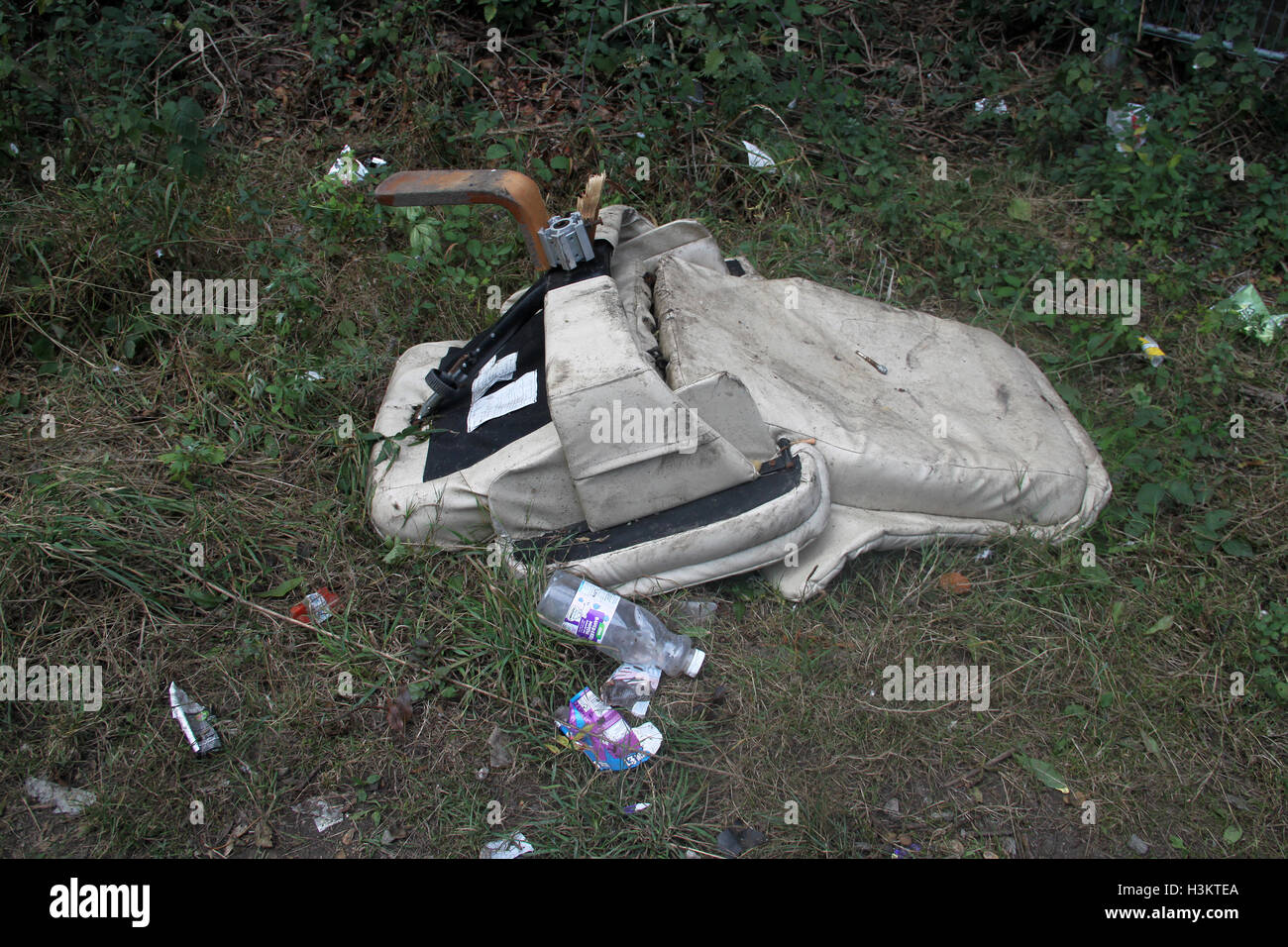 Abandoned broken chair and litter in countryside Stock Photo
