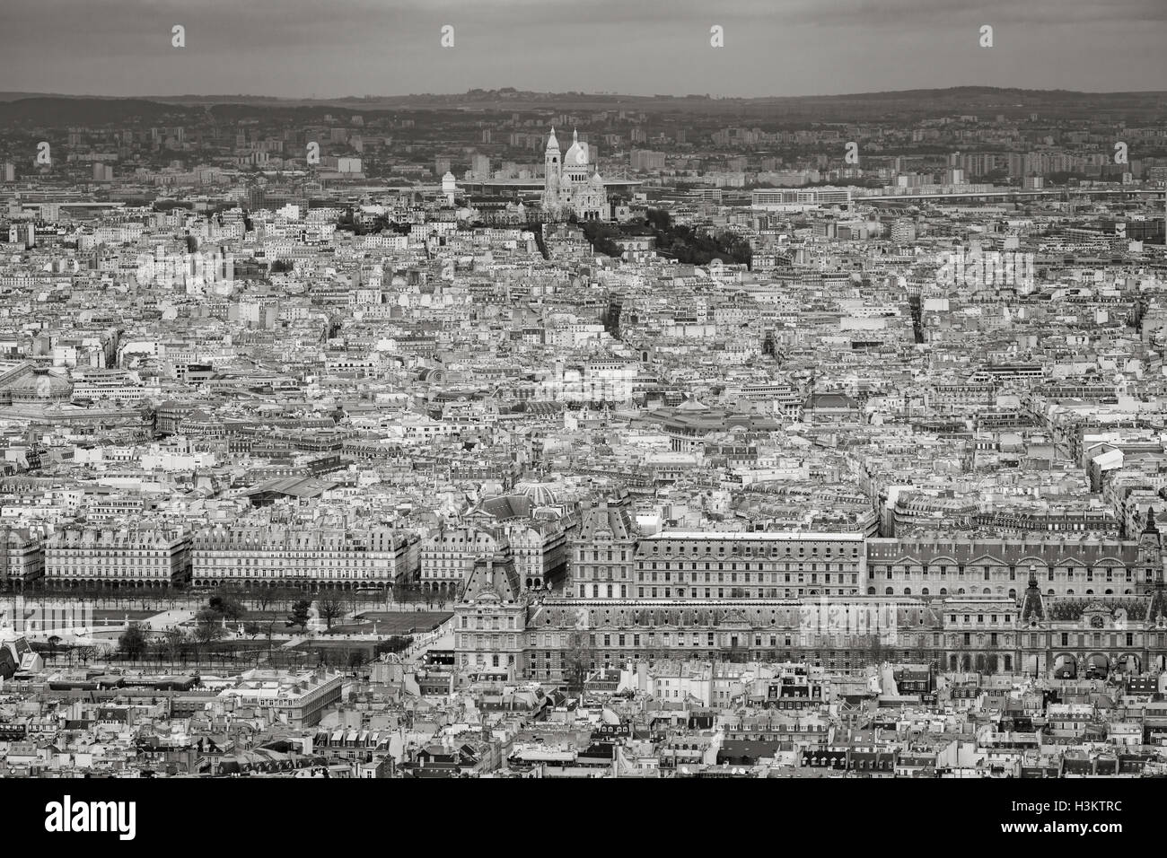 Aerial view of Paris rooftops with The Louvre, Tuileries Garden and Sacre Coeur Basilica in Montmartre. France (Black & White) Stock Photo