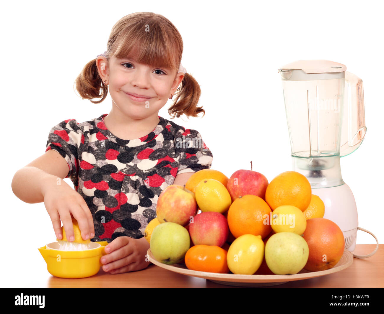 happy little girl make fruit juice Stock Photo Alamy
