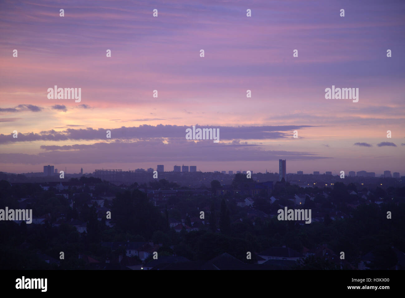 Twilight or dusk panoramic view of Glasgow Scotland with darkness and street lights purple sky Stock Photo