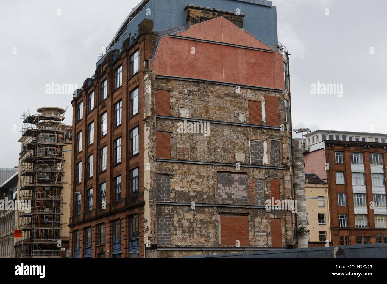 Glasgow merchant city regeneration building end face with signs of