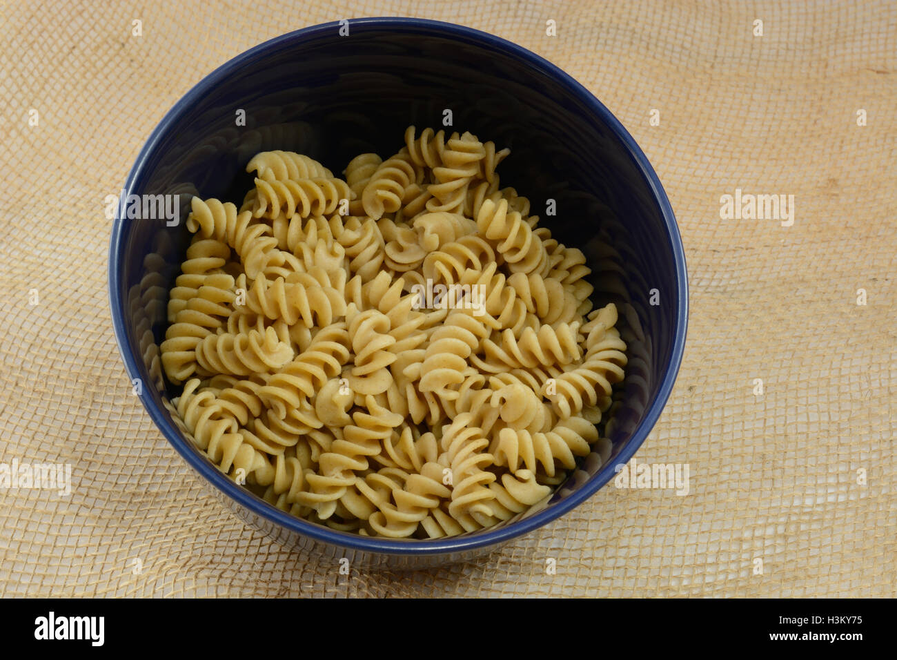 Cooked Whole wheat Rotini pasta in blue bowl Stock Photo Alamy