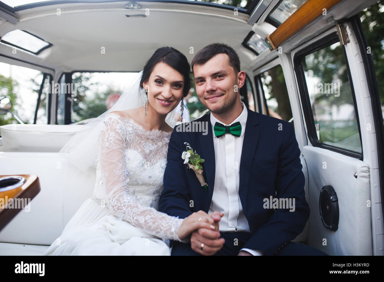 bride and groom sitting in the car Stock Photo - Alamy