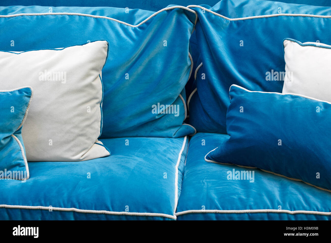 Sofa detail in blue tone with cushions. Horizontal Stock Photo