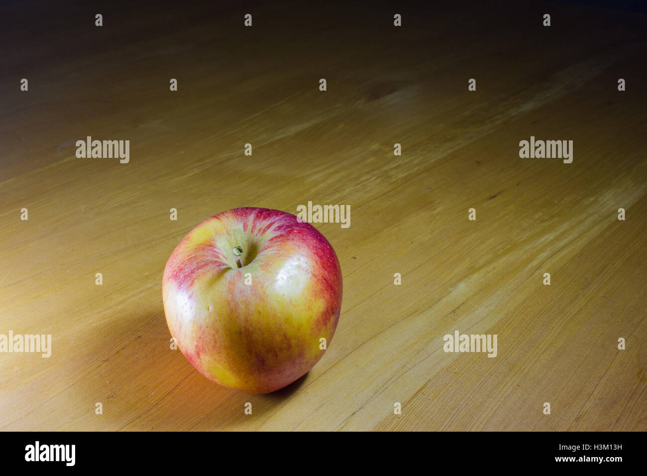 Red apple on wood table Stock Photo