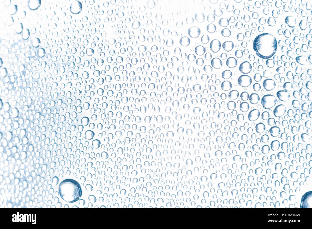Abstract image of beads of water condensation on the inside of a PTFE bottle. Image exposure pushed to give blown-out look. Water Day concept. Stock Photo