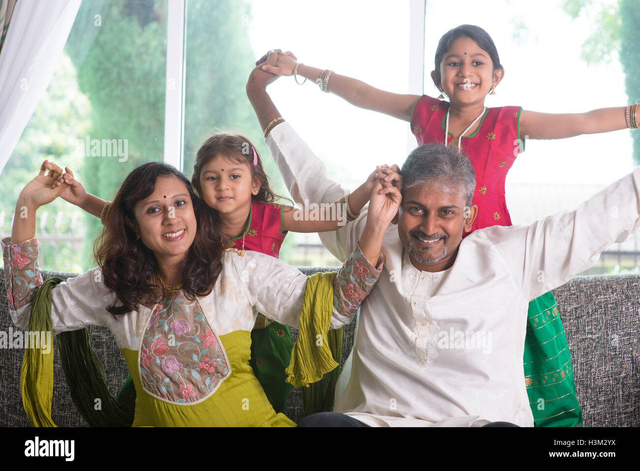Happy indian family holding hi-res stock photography and images - Alamy