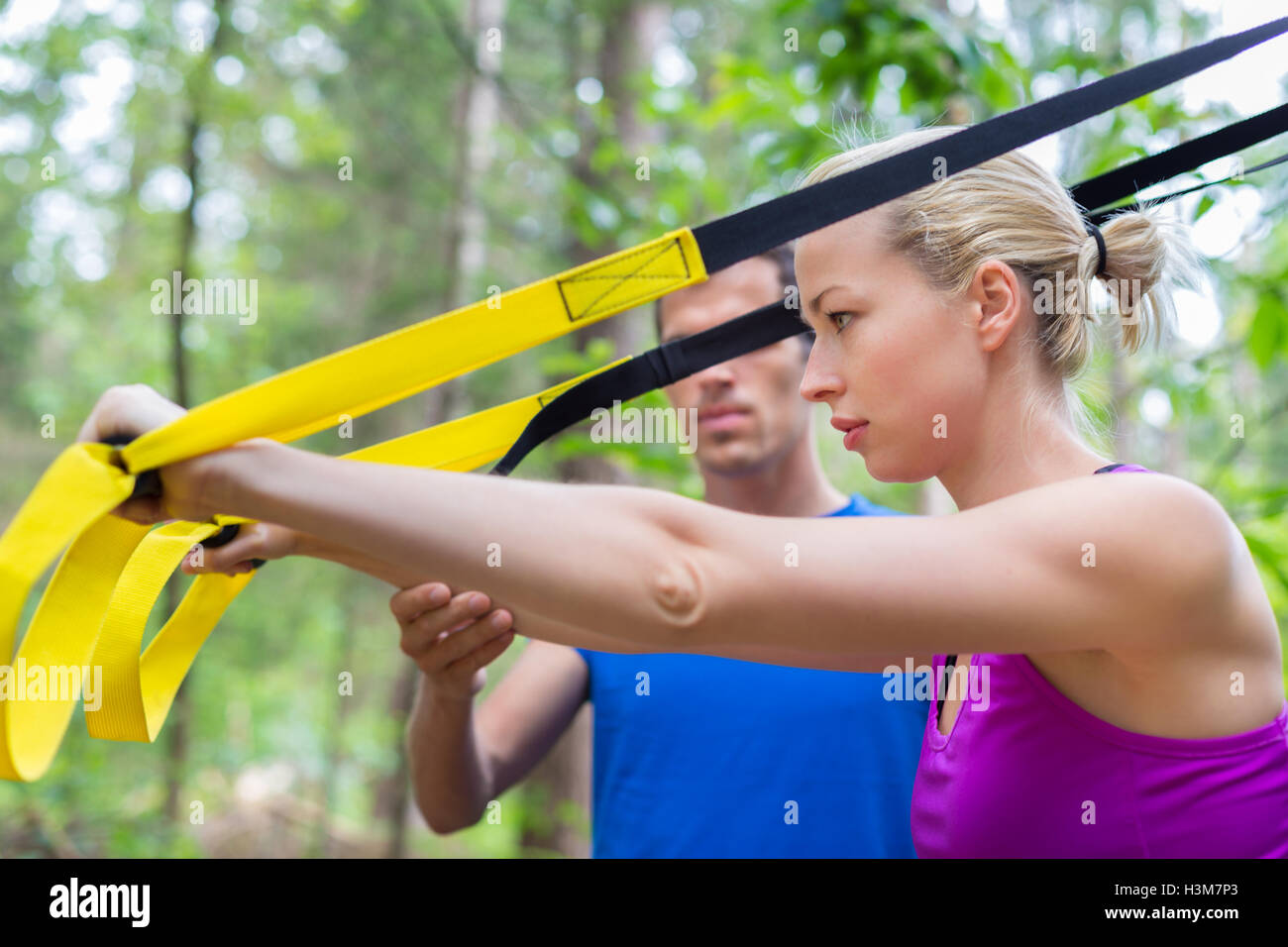 Training with fitness straps outdoors Stock Photo - Alamy
