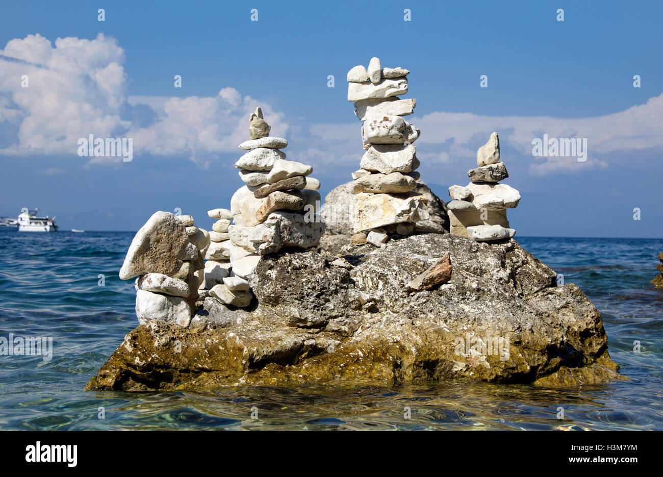 Stone balancing Gaios Harbour Paxos Ionian Islands Greece Stock Photo
