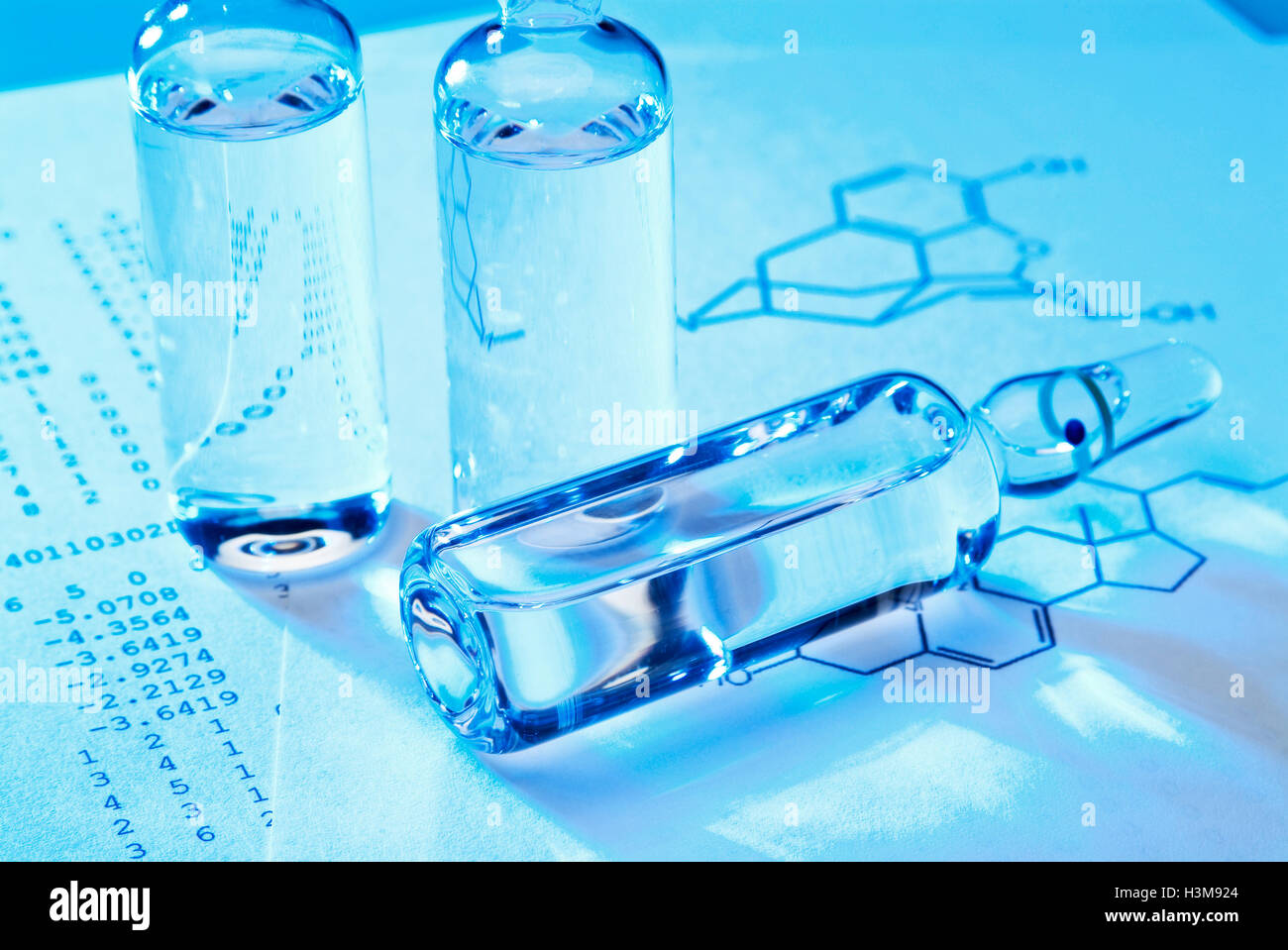 Vials with grout on a document with structural formula. Stock Photo