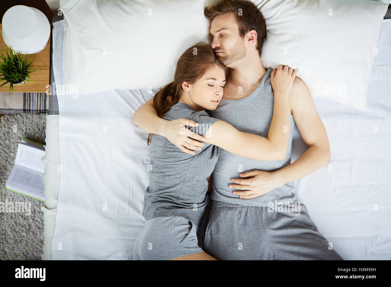 Restful couple sleeping in embrace Stock Photo