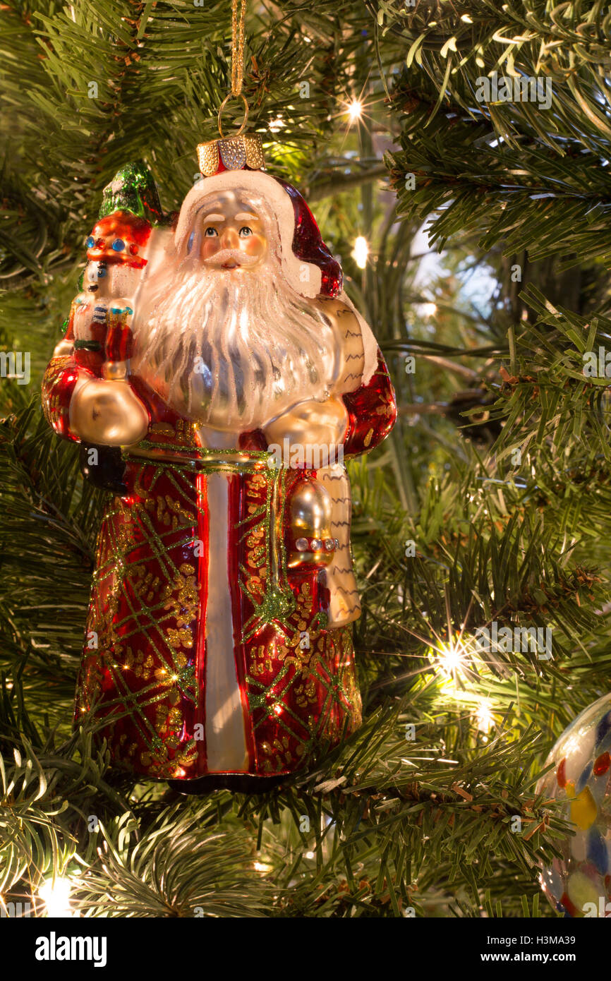 A hand blown glass ornament in the shape of a vintage Santa Claus with a sack full of gifts. Stock Photo